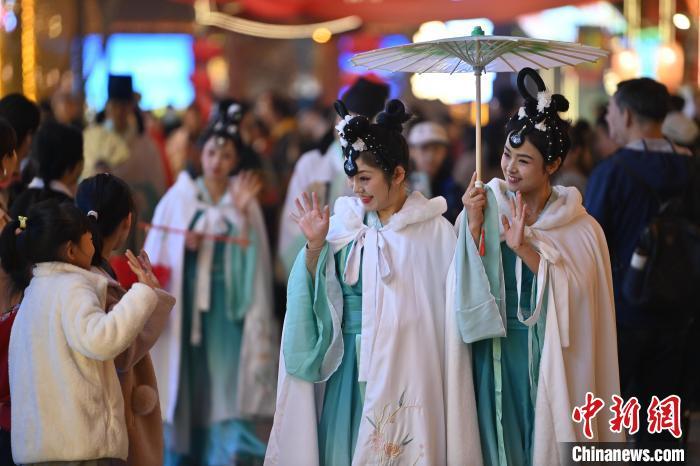 圖為街區(qū)人員著傳統(tǒng)服飾與游人互動(dòng)。李亞龍 攝</p><p>